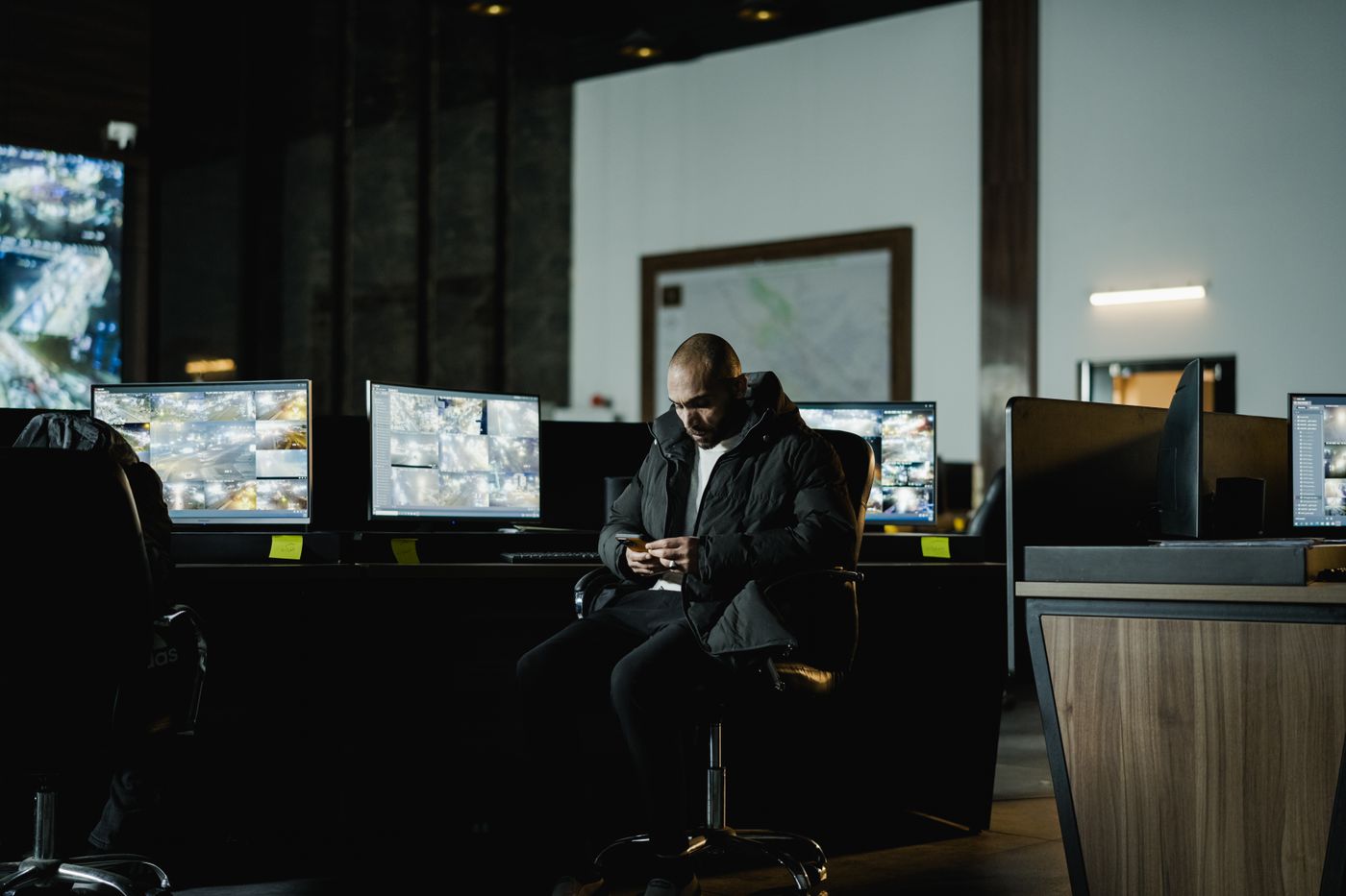 Security officer watching camera feeds in a control room