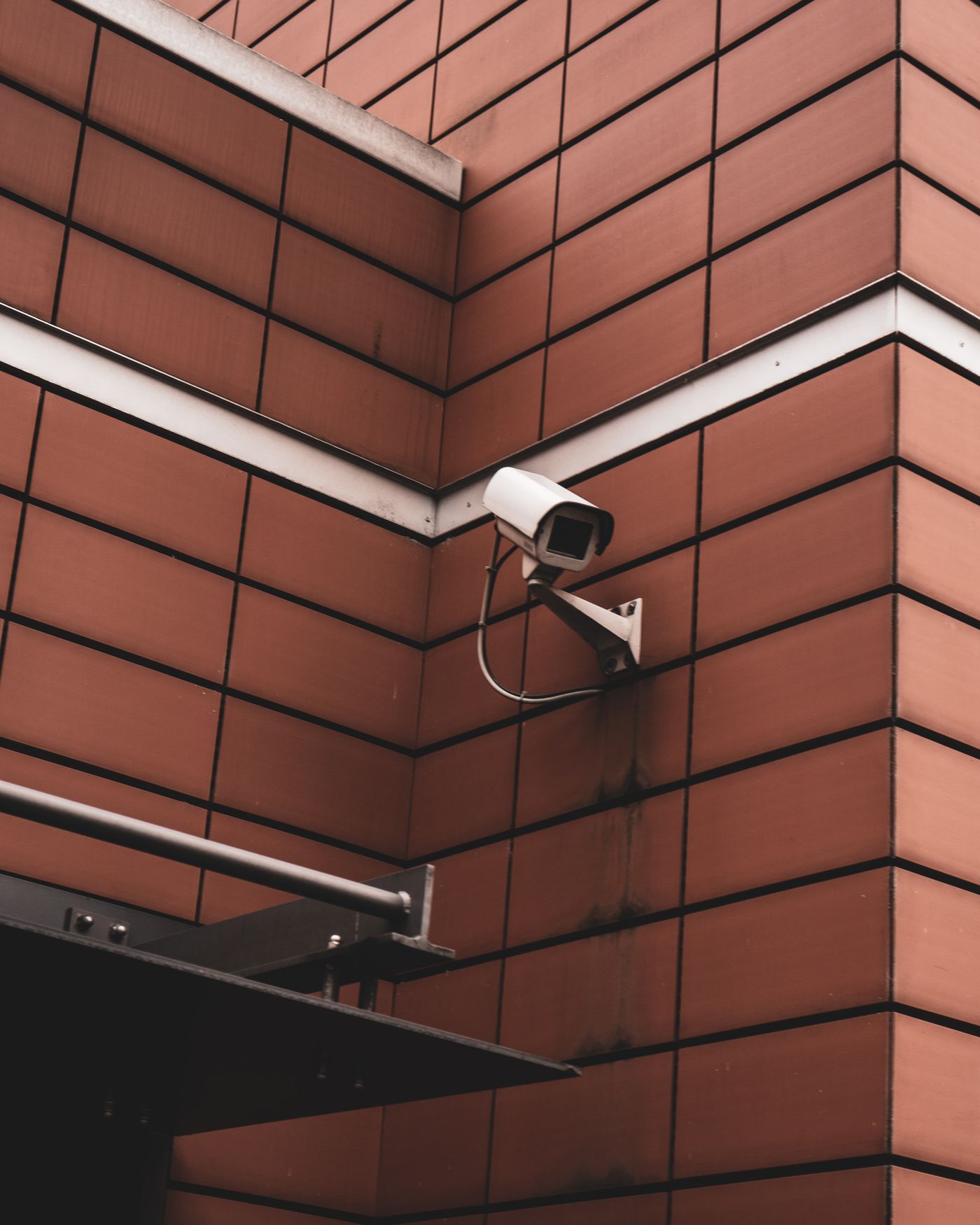 A CCTV camera fitted on a brick building wall