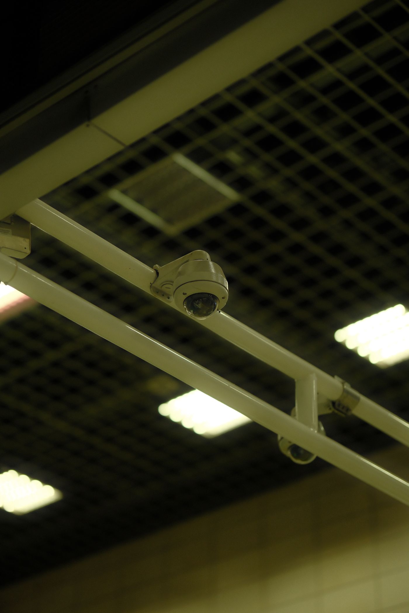 A dome CCTV camera fixed on an office ceiling